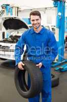 Mechanic holding a tire wheel