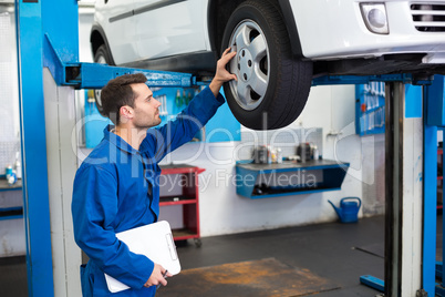 Mechanic looking at car tires