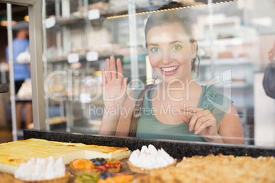 Pretty brunette looking at pastrys