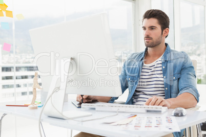 Focused designer working with digitizer and computer