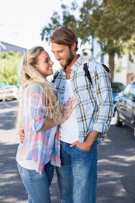 Attractive couple standing and hugging