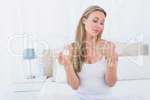 Woman choosing her medicine on bed
