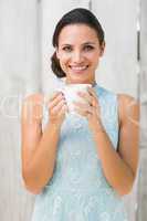 Stylish brunette holding a mug