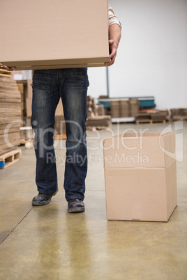 Worker with box in warehouse