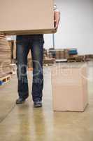 Worker with box in warehouse