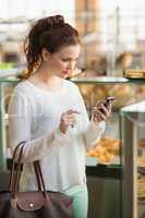 Pretty brunette sending a text