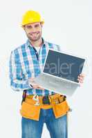 Happy construction worker showing laptop