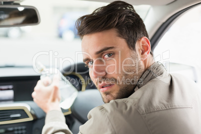 Man drinking alcohol while driving