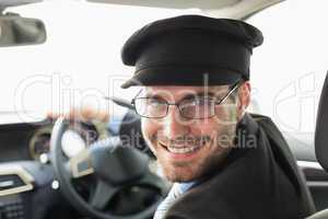 Handsome chauffeur smiling at camera