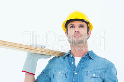 Worker carrying wooden planks