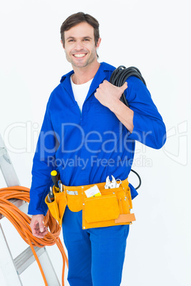 Happy electrician with wires over white background