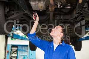 Mechanic examining under the car