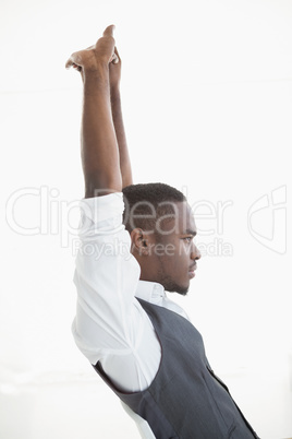 Smiling businessman stretching his arms