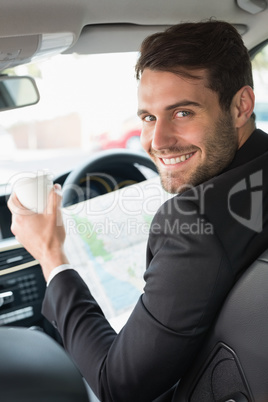 Young businessman reading a map