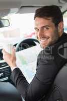 Young businessman reading a map