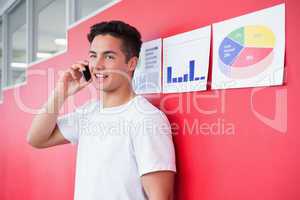Smiling student on the phone standing