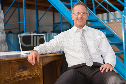 Smiling warehouse manager with computer Smiling warehouse manager with computer