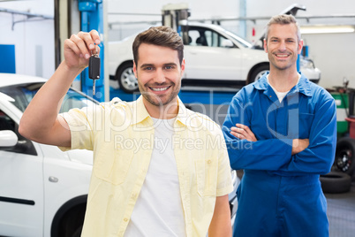 Customer and mechanic smiling at camera