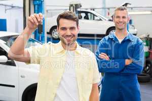 Customer and mechanic smiling at camera