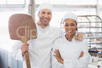 Team of bakers smiling at camera