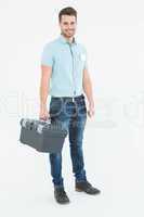 Confident male technician carrying toolbox