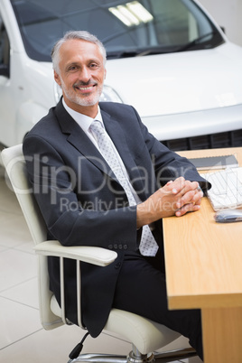 Happy businessman working at his desk