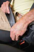 Close up of man putting seat belt