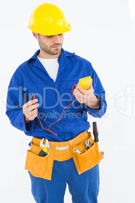 Repairman examining multimeter