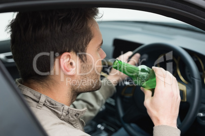 Man drinking beer while driving