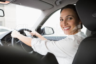 Woman smiling at camera while driving