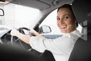 Woman smiling at camera while driving