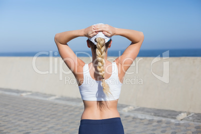 Fit blonde standing on the pier