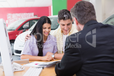 Smiling couple reading a booklet