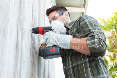 Carpenter using drill machine