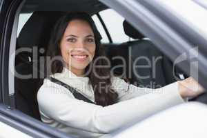 Pretty woman smiling and driving