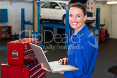 Mechanic typing on a laptop