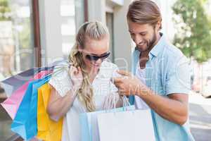 Attractive couple looking at shopping purchases