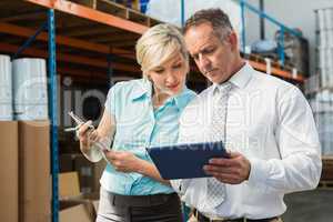 Warehouse managers looking at tablet pc
