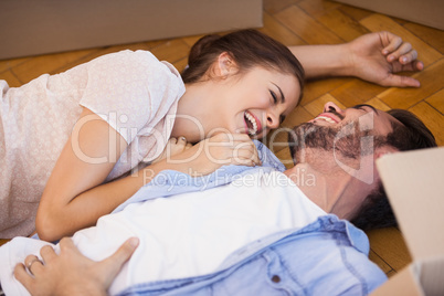 Smiling couple lying on the floor