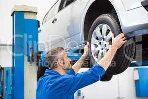 Mechanic adjusting the tire wheel