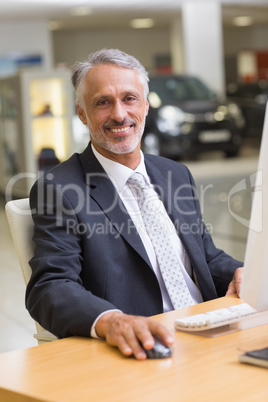 Cheerful businessman working at his desk