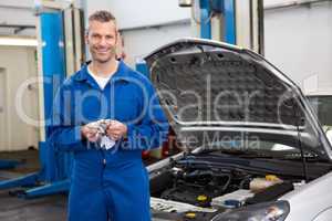 Smiling mechanic looking at camera