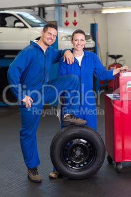 Team of mechanics smiling at camera