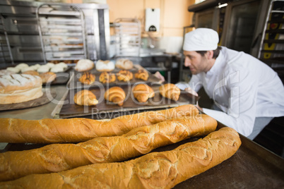 Baker checking freshly baked bread