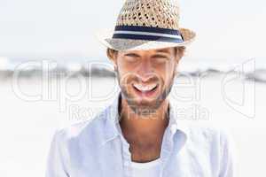 Handsome man smiling at camera on promenade