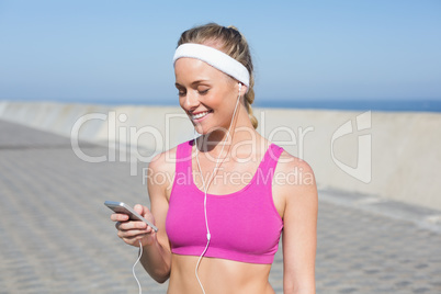 Fit blonde standing on the promenade