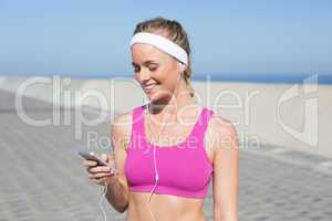 Fit blonde standing on the promenade