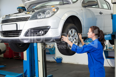 Mechanic adjusting the tire wheel Mechanic adjusting the tire wheel