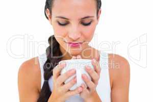 Pretty brunette having cup of tea