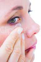 Close up of woman applying contact lens